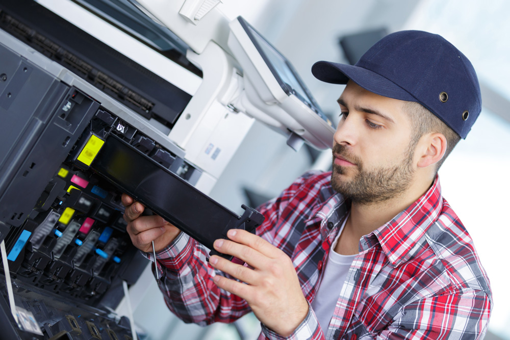 man repairing a printer at work PBV787T small